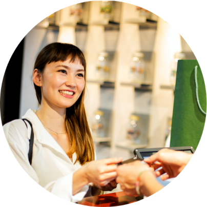 A person holds several US hundred-dollar bills.