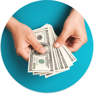 A person holds several US hundred-dollar bills.