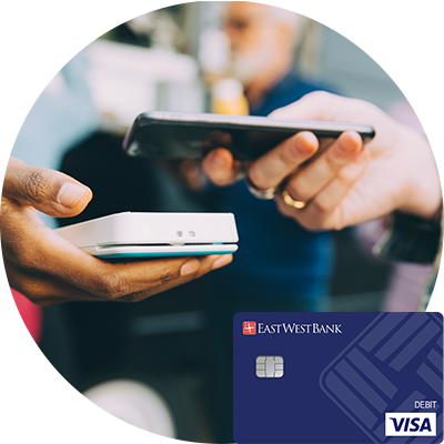 A person uses their phone to pay on a point-of-sale device.