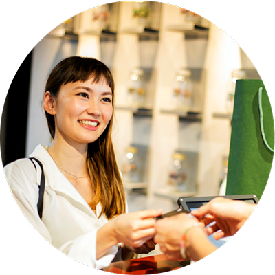 A person holds several US hundred-dollar bills.