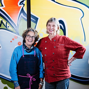 Chefs Susan Feniger and Mary Sue Milliken at Socalo Santa Monica that features street art by Clark Oswald. Photo by East West Bank.