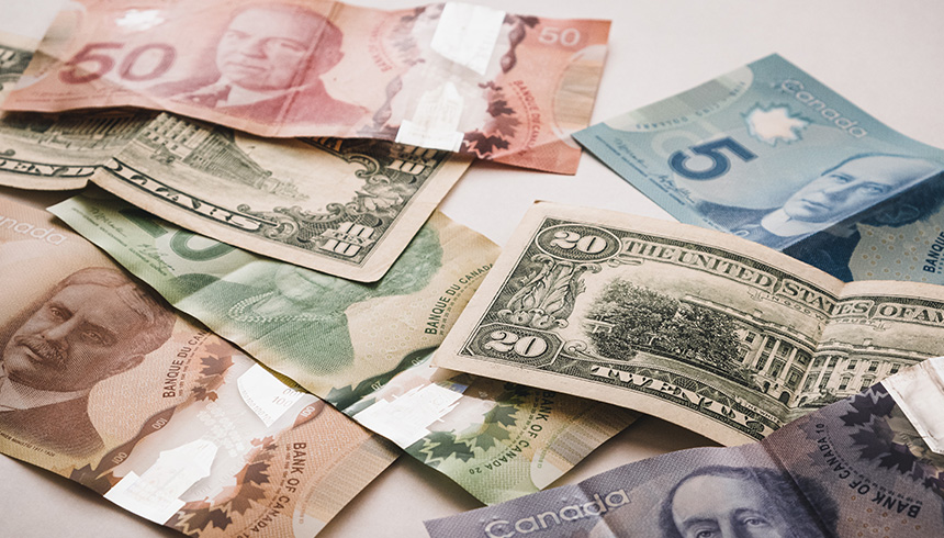 different country paper currency of different denomination bills on a a surface