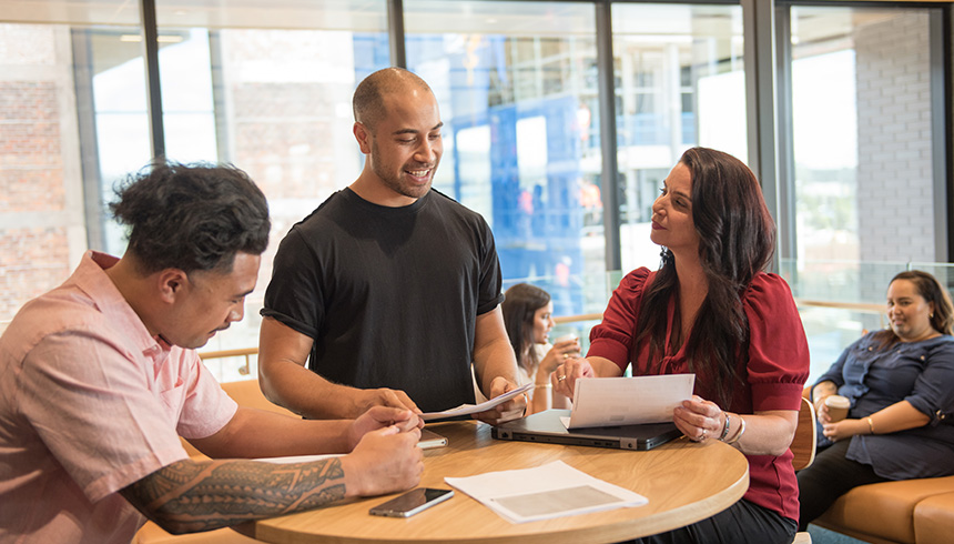 A team indoors, grouped to discuss the problem