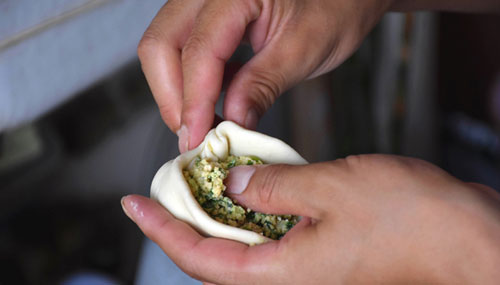 Folding the cheese steamed buns
