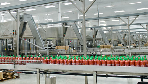 Sriracha bottles on factory floor of Huy Fong Foods