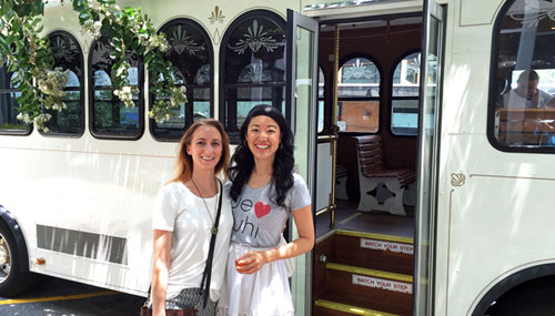 Marian Liou and her friend standing in front of We Love BuHi public trolley