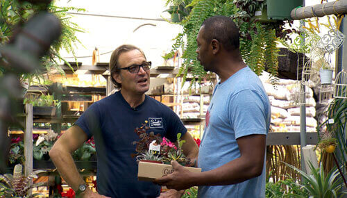  Dennis Kuga, the owner of Sunset Nursery, in talking to a customer in the nursery garden 