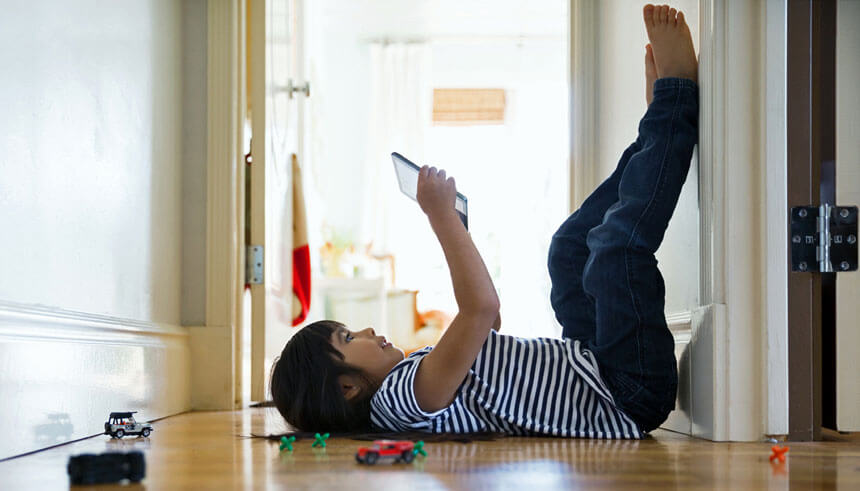 Little girl playing on digital tablet