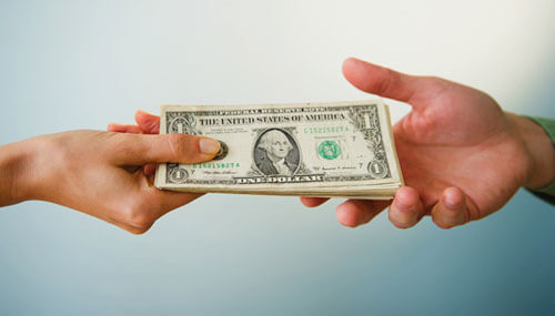Close up of man's and woman's hands holding banknotes