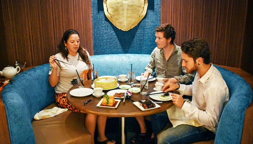 People eating at a booth of Las Vegas Pearl Ocean restaurant