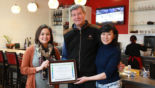 Tom and Wenyan Peterson on the right, with a certificate for Noodles Fresh