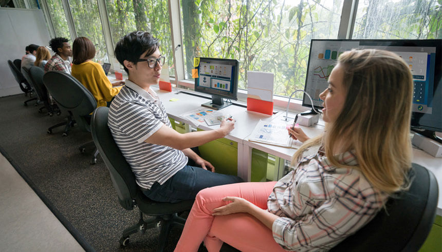 Two people working at a co-working space