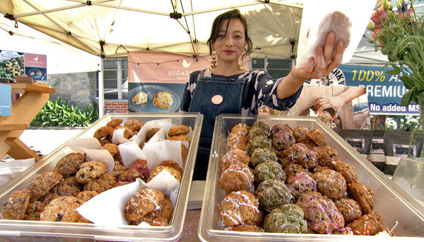 Kei Okumura, owner of Sugarbird Sweets and Teas, at a farmer's market 