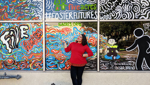 Mary near the mural that was created with contributions to create awareness of children in foster care