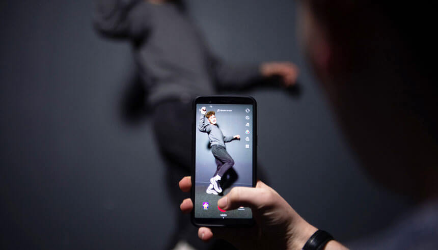 A person poses for the picture using Chinese short-form video sharing app TikTok