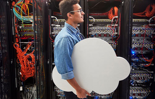 IT technician carrying cloud in server room