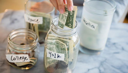 Putting money in jars and saving it for the future