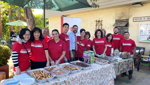 Rabbi Joshua Levine Grater (center) with East West Bank volunteers serving breakfast