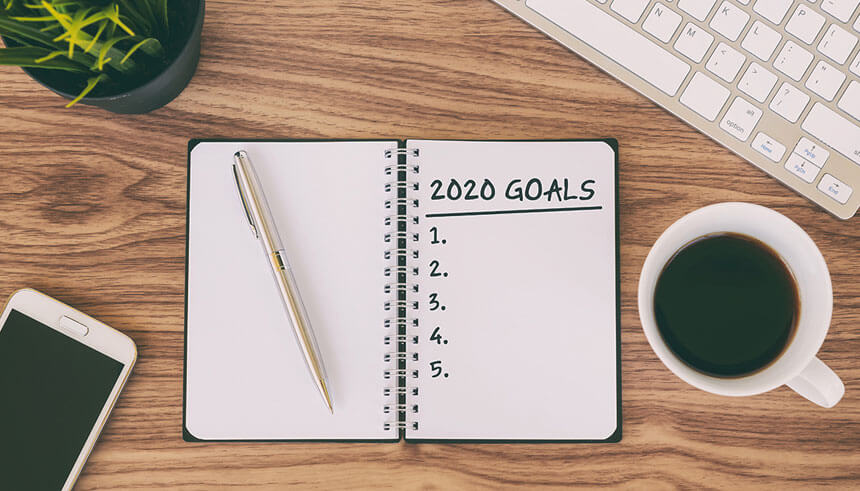 2020 business goals written on a notepad