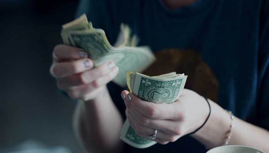 hands counting US dollar bills